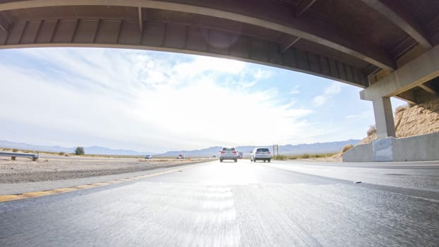 Embarking on a road trip from Nevada to California, driving on Highway 15 during the day offers scenic views and an exciting journey between states.