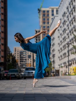 Beautiful Asian ballerina dancing outdoors. Urban landscape