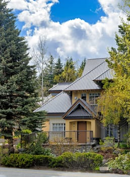 Entrance of luxurious residential house with big roof on spring season in Canada
