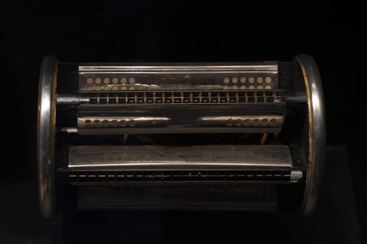 six sided harmonica isolated on black background