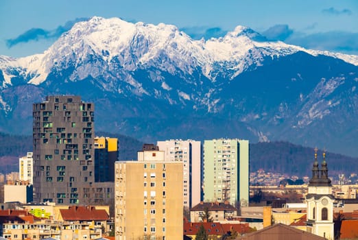Ljubljana, Slovenia: High-rise modern residential buildings and picturesque snowy Alps in the background