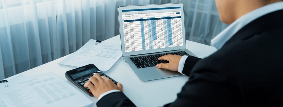 Corporate accountant use accounting software on laptop to calculate and maximize tax refunds and improve financial performance based on financial data. Modern business accounting in panorama. Shrewd