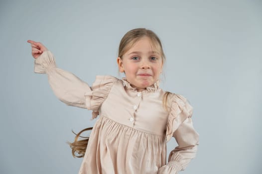 Little Caucasian girl having fun and making faces on a white background