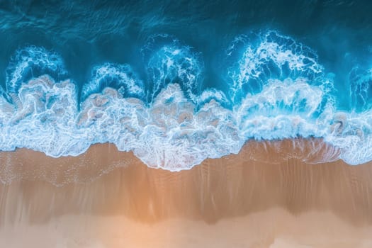 The ocean waves are crashing against the shore, creating a beautiful and calming scene. The water is a deep blue color, and the sand is a light brown color. The waves are moving in a rhythmic pattern