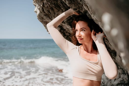 Happy young attractive brunette woman in red swimsuit, on the beach and sea background. Holiday vacation and travel concept.