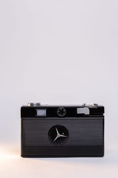 Vintage film camera with a sleek silver body and a classic black manual focus lens, elegantly displayed against a clean white background.