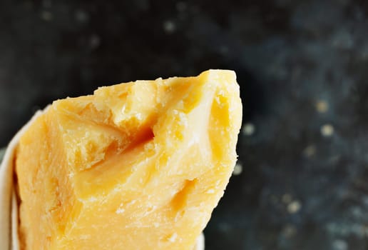 Italian hard cheese Parmesan -Parmigiano Reggiano produced from cow's milk on dark table 