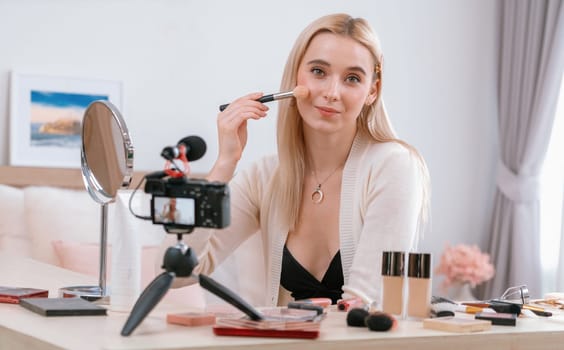 Young woman making beauty and cosmetic tutorial video content for social media. Beauty blogger smiles to camera while showing how to beauty care to audience or followers. Panorama Blithe