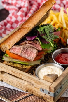 Grilled steak sandwich with french fries on a white porcelain plate