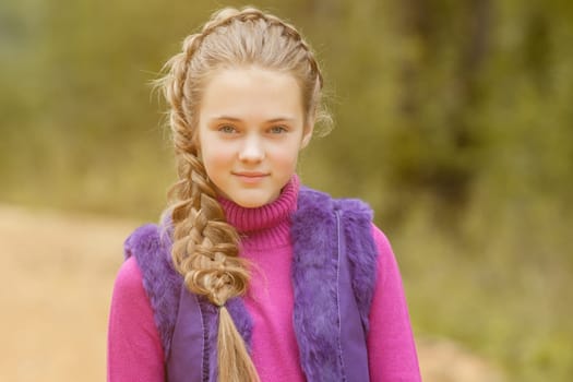 Portrait of smiling pretty girl walking in park, close-up