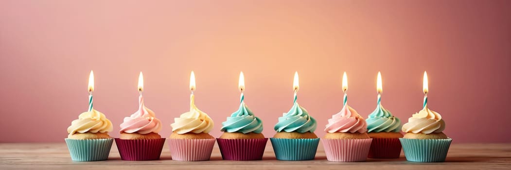 Colorful cupcakes with lit candles are displayed against a pink background, indicating an indoor celebration event marking of joy and celebrating. with free space.