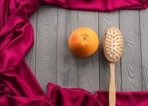 skin preparation body beach anti-cellulite massage cactus brush big orange peel. Summer background template mockup free space pattern composition sample text. Top view above grey wooden background
