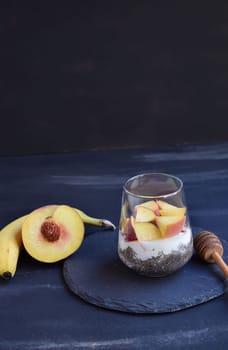 Healthy breakfast with chia seeds, yogurt, fruit and honey.