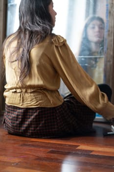 young beautiful woman applying makeup near the mirror