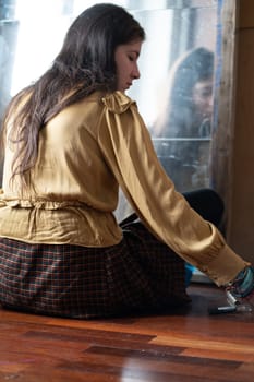 young beautiful woman applying makeup near the mirror