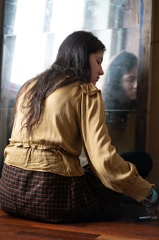 young beautiful woman applying makeup near the mirror