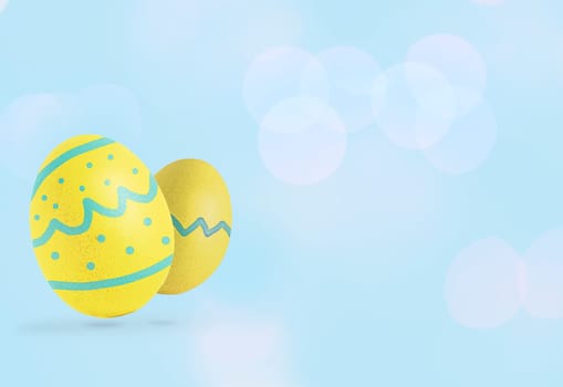 Yellow Easter eggs on pastel blue background. Copy space.
