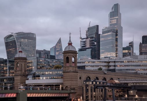 London, UK - Feb 27, 2024 - Beautiful view of Skyscrapers and The cannon street railway bridge in the business district Looking through Southwark bridge in city of london. Architectural modern buildings, Copy space, Selective Focus.