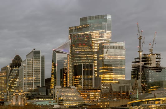 London, UK - Feb 15, 2024 - The illuminated of skyscraper in the business district of London just after sunset. View of architectural modern buildings of the city, Copy space, Selective Focus.