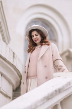 woman in elegant attire against an intricate architectural backdrop, harmoniously blending modern fashion with historical allure. The soft daylight adds to its timeless appeal