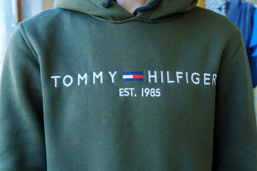 Tyumen, Russia-January 11, 2024: Man wearing a Tommy Hilfiger sweatshirt, exuding a trendy and casual style.