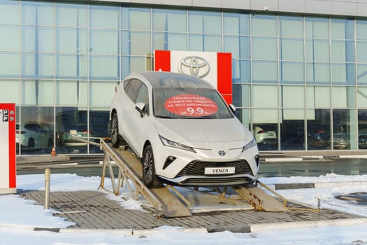 Tyumen, Russia-March 02, 2024: Toyota Venza is showcased on an inclined ramp outside a showroom.