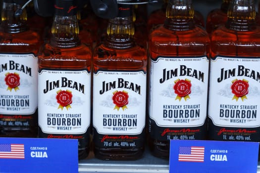 Tyumen, Russia-March 02, 2024: Collection of various bourbon Jim beam bottles neatly arranged on a store shelf