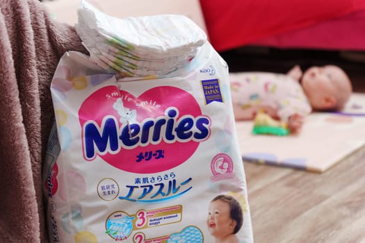 Tyumen, Russia-March 02, 2024: Merries diapers is placed on top of a wooden table, showcasing the brands logo and packaging design.