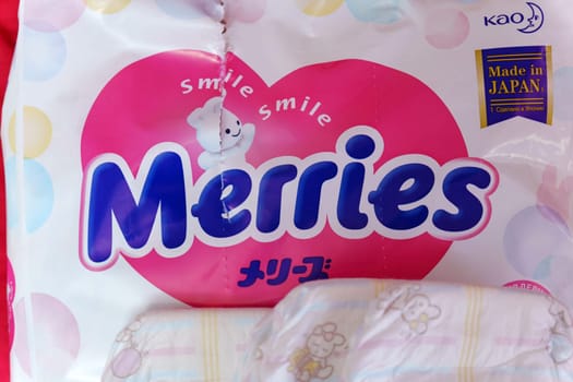 Tyumen, Russia-March 02, 2024: Detailed close-up of a bag of Merries baby diapers, showcasing the brand logo and packaging design.