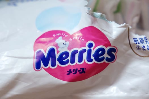 Tyumen, Russia-March 02, 2024: Detailed close-up of a bag of Merries baby diapers, showcasing the brand logo and packaging design.