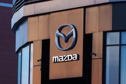 Tyumen, Russia-March 18, 2024: Mazda logo is prominently featured on the side of a building, standing out against the background.