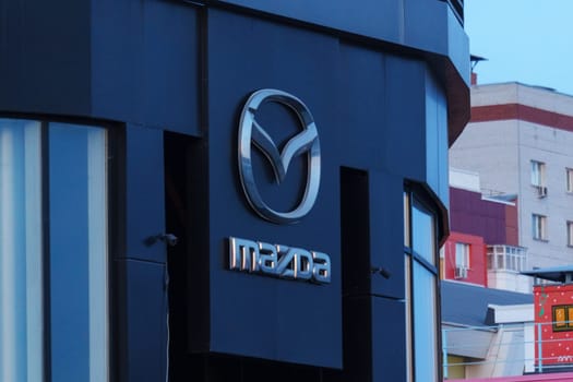 Tyumen, Russia-March 18, 2024: Mazda logo prominently. The logo is identifiable and adds to the buildings branding.