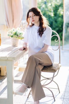 Portrait of a Russian young girl sitting on a chair