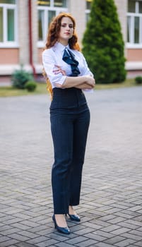 Portrait of a high school student against the backdrop of the school