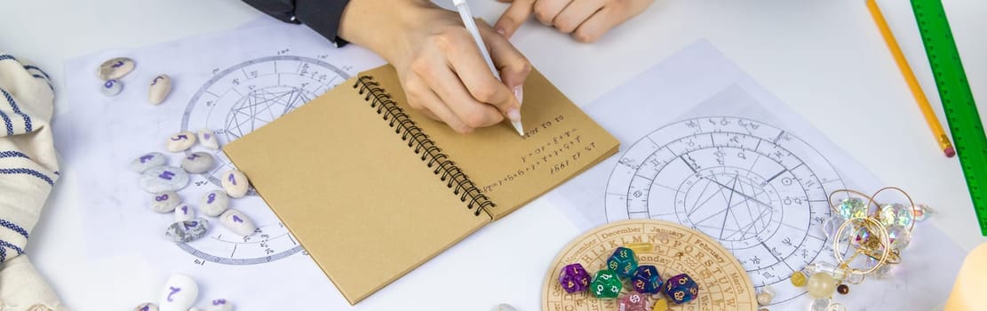 Woman numerologist astrologer counts numbers. Selective focus. People.