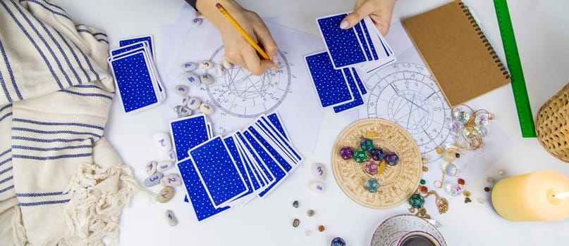 Woman astrologer draws a natal chart. Selective focus. People.