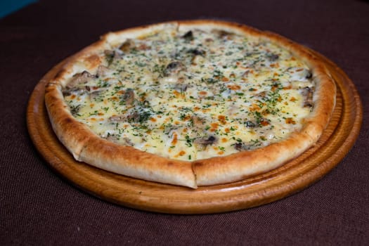 Delicious pizza with a crispy crust, topped with gooey melted cheese, flavorful mushrooms, and fragrant herbs for a satisfying meal.