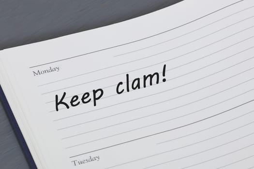 A Keep calm reminder message in an open diary