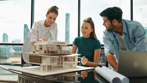 Smart architect team discussion about house design while handsome male worker present idea by using laptop. Group of professional engineer sharing, brainstorming design. Business design. Tracery