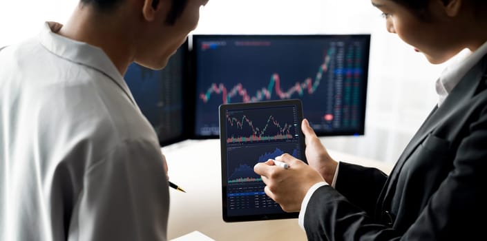 Cropped image of professional broker show tablet displayed growth graph in skilled trader at stock market. Stock investment. Stock trading. Stock market trading concept. Burgeoning.