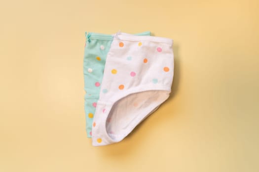 Children's underpants on a beige background. Polka dot panties for girls
