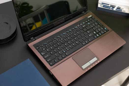 Corporate workplace with a laptop, calendar and pens prepared for a new employee. A new workplace with computer work.