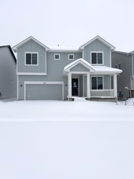 Castle Rock, Colorado, USA-March 16, 2024-Fresh snowfall gently covers a new suburban neighborhood under construction, where the emerging structures await completion, nestled in a wintery setting.