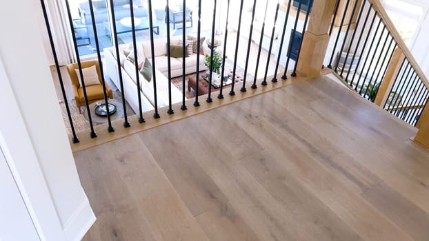 The image captures the detail of a well-designed modern staircase, lined with plush beige carpet, complemented by white walls and wooden balusters.