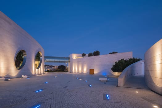 Lisbon, Portugal - January 13, 2023: Modern architecture of the Champalimaud foundation building - Portuguese non-profit foundation for scientific medical research in Belem illuminated in night time