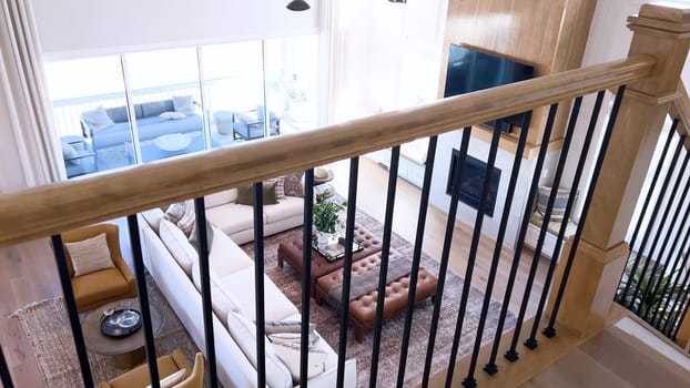 The image captures the detail of a well-designed modern staircase, lined with plush beige carpet, complemented by white walls and wooden balusters.