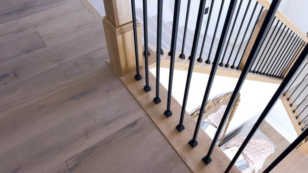 The image captures the detail of a well-designed modern staircase, lined with plush beige carpet, complemented by white walls and wooden balusters.