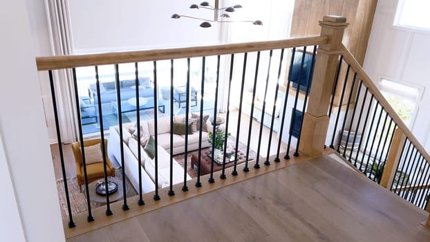 The image captures the detail of a well-designed modern staircase, lined with plush beige carpet, complemented by white walls and wooden balusters.