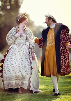 Medieval, lawn and couple in history with renaissance fashion outdoor with marriage and love. Vintage, king and royal leader with queen together on a garden with conversation and theater costume.