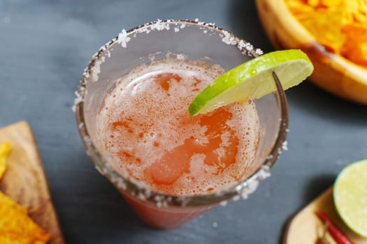 Michelada, Mexican alcoholic cocktail with beer, lime juice, tomato juice